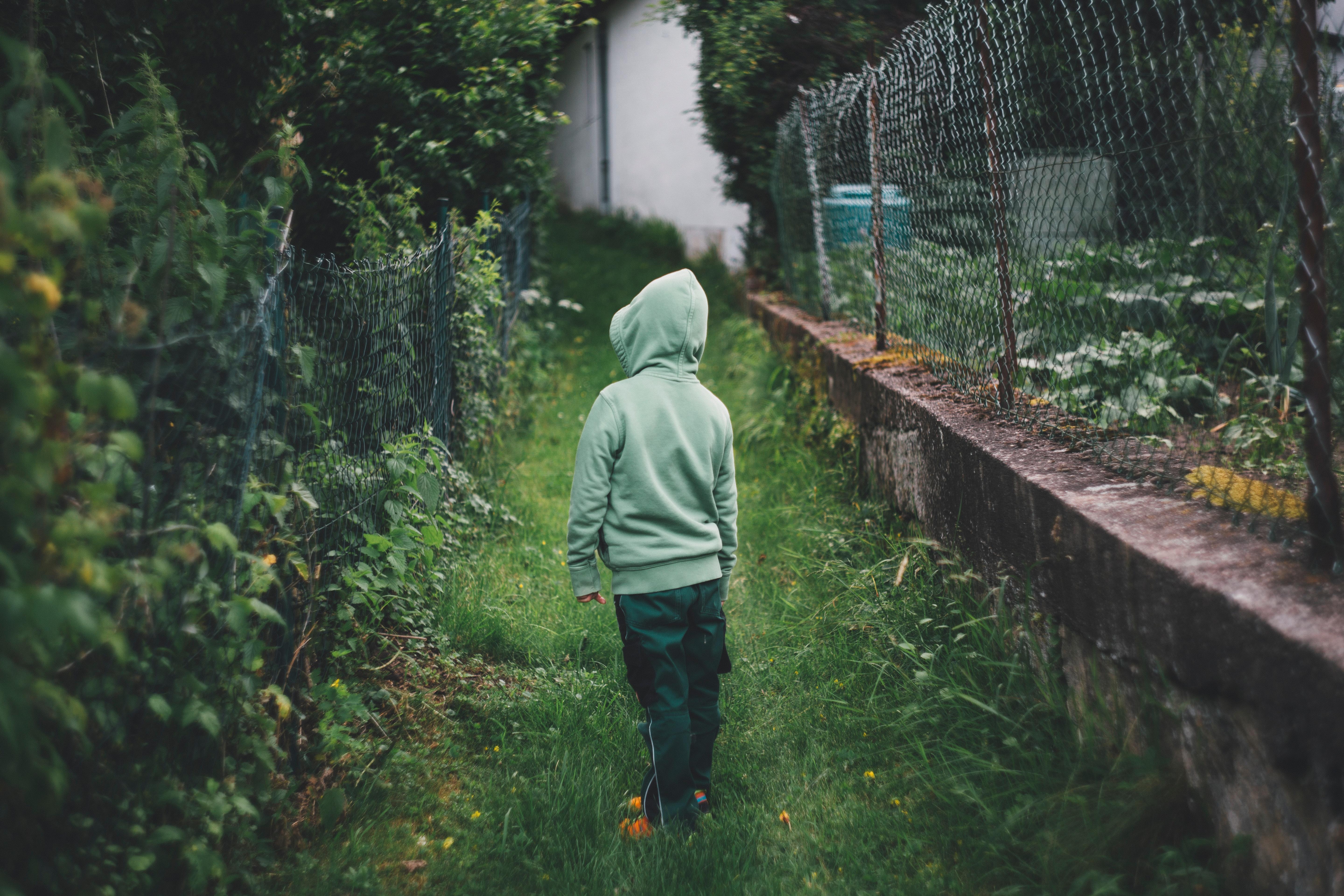 Child with back to camera in garden